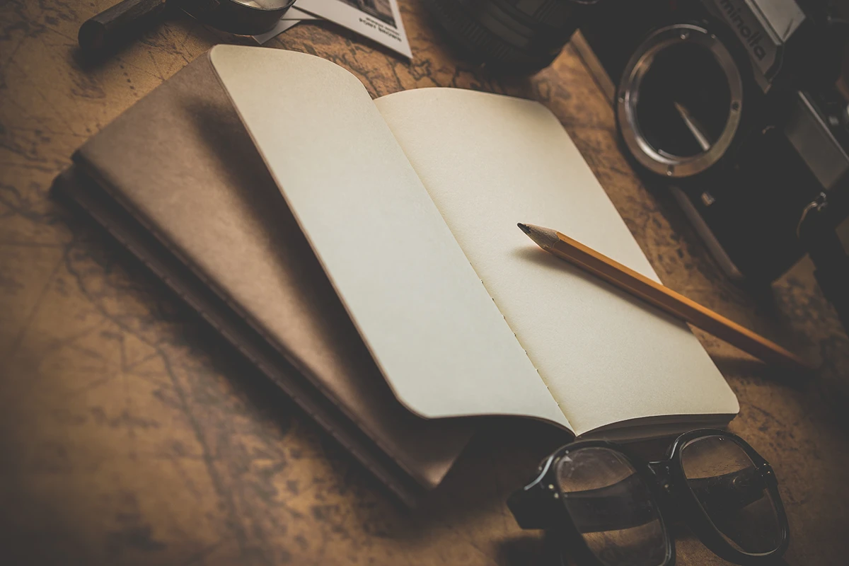 Photo of a pencil and notebook